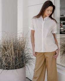 Female model looking down wearing Nili Lotan Shirt and Vince Pant