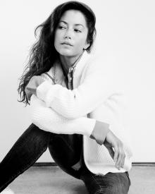 Black and white photo of model sitting on floor against white wall wearing 6397 Shirt & Cardigan and R13 Jean