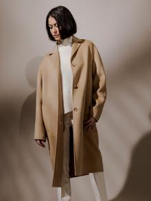 Model wearing tan long coat 