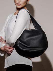 Model wearing black leather bag